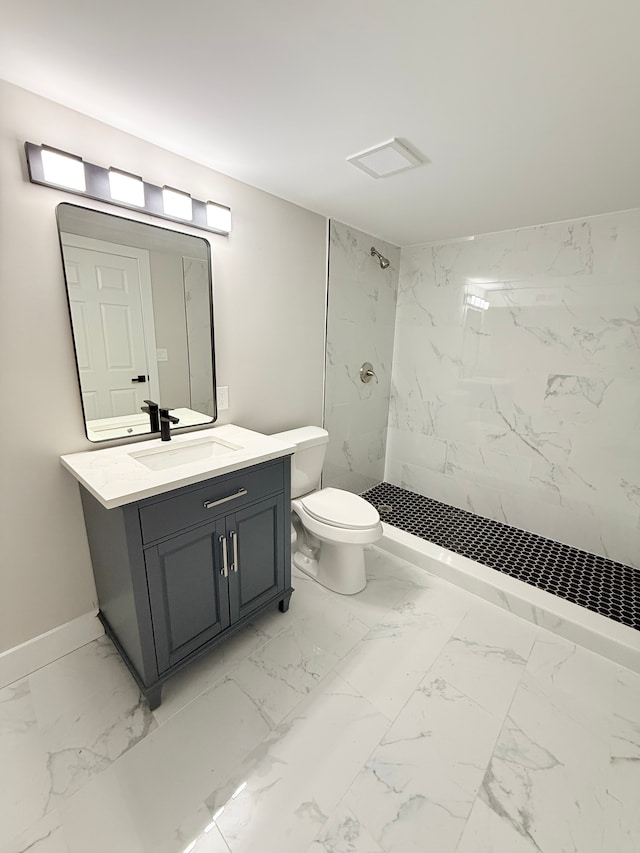 full bathroom with marble finish floor, toilet, a stall shower, vanity, and baseboards