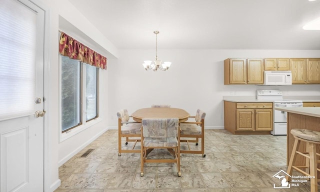 dining room with baseboards, visible vents, and a notable chandelier