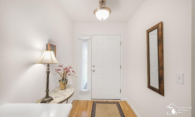 entrance foyer featuring light wood-style flooring and baseboards