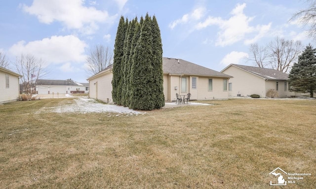 rear view of house featuring a yard and a patio