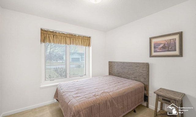 bedroom with carpet floors and baseboards