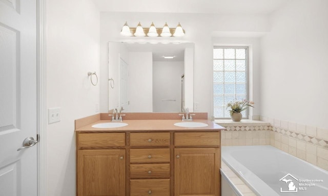 full bath featuring a garden tub, a sink, and double vanity