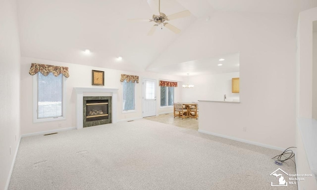 unfurnished living room with carpet floors, a fireplace, high vaulted ceiling, and baseboards