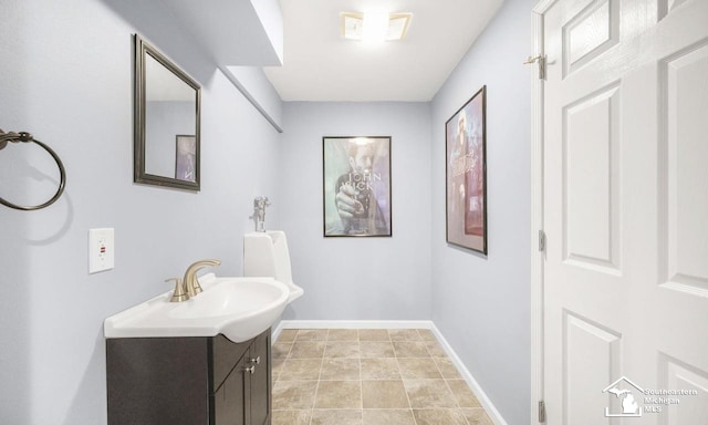 bathroom with vanity and baseboards