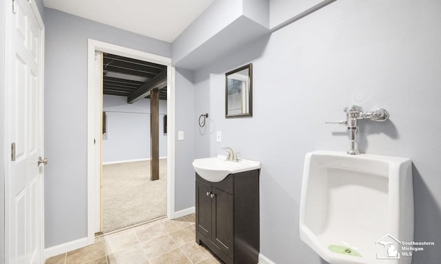 bathroom featuring tile patterned floors, baseboards, and vanity