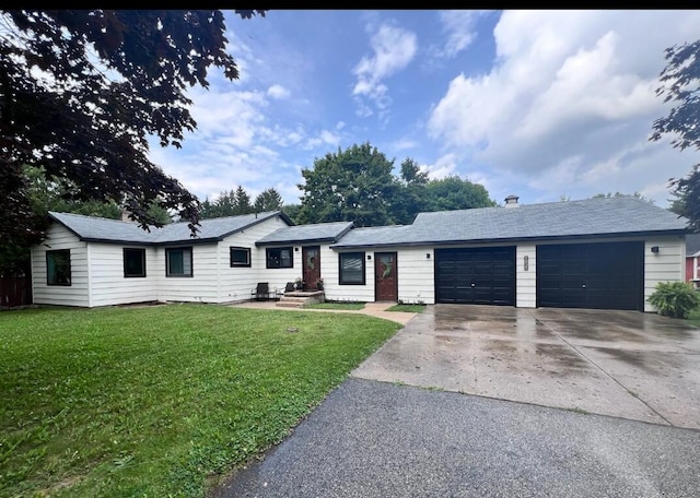 single story home featuring a garage, a front yard, and driveway