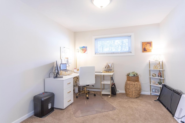 office area featuring light carpet and baseboards