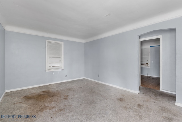 empty room featuring carpet floors and baseboards