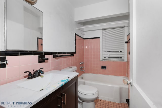 full bathroom featuring vanity, shower / tub combination, toilet, and tile walls