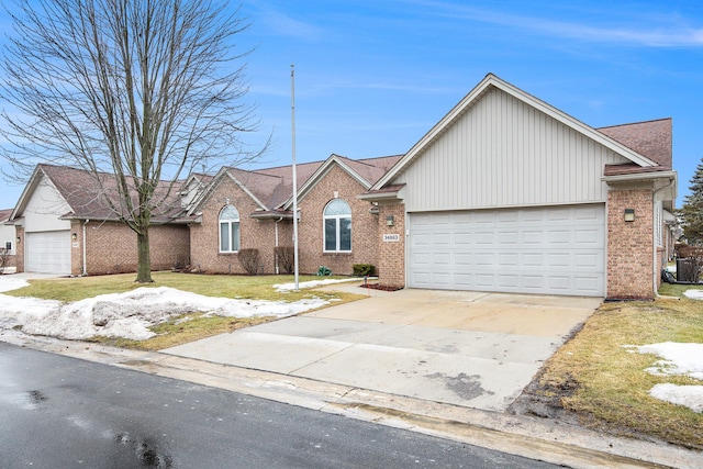 ranch-style home featuring a front yard, concrete driveway, brick siding, and an attached garage