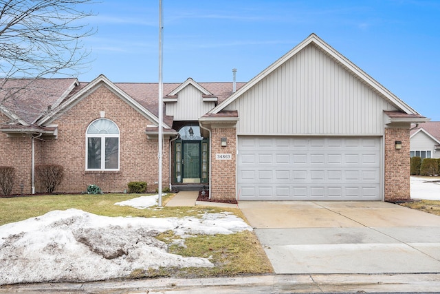 view of front of property featuring a garage, concrete driveway, brick siding, and a shingled roof