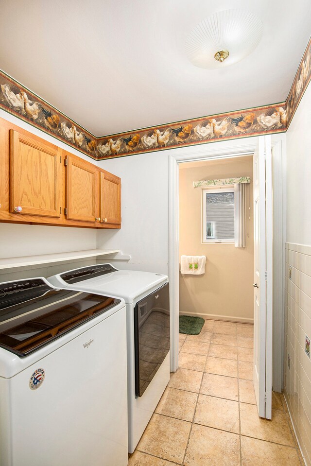 washroom featuring light tile patterned flooring, tile walls, and independent washer and dryer