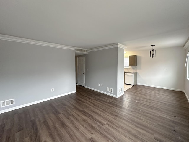 unfurnished room featuring crown molding, dark wood-style flooring, visible vents, and baseboards