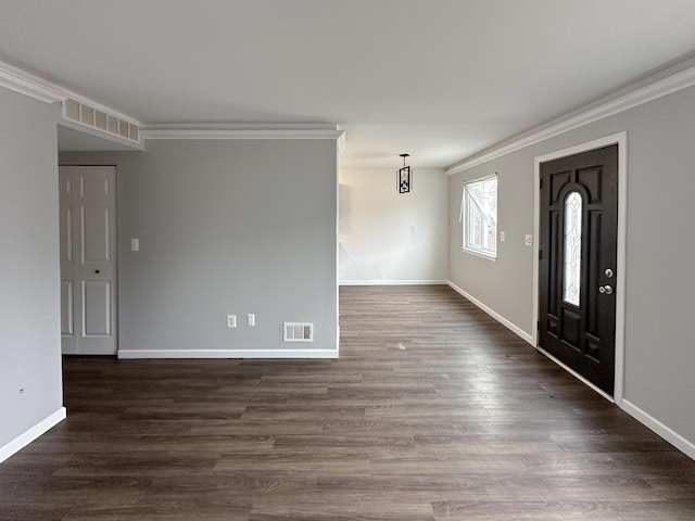 entrance foyer with dark wood-style floors, visible vents, and crown molding