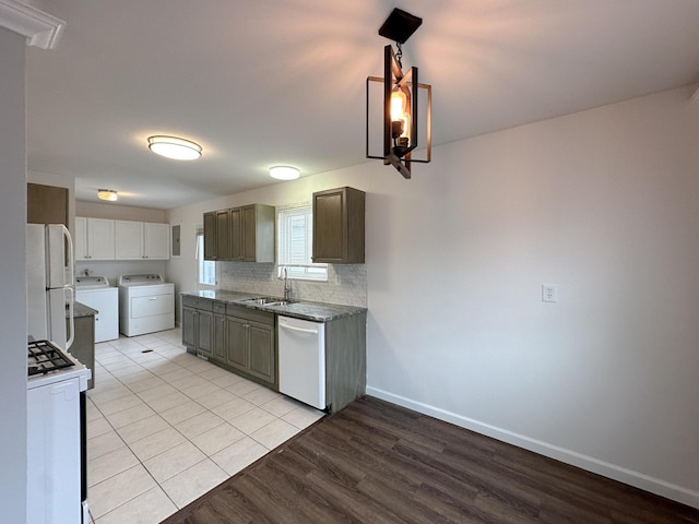 kitchen with white appliances, baseboards, washer and clothes dryer, a sink, and backsplash