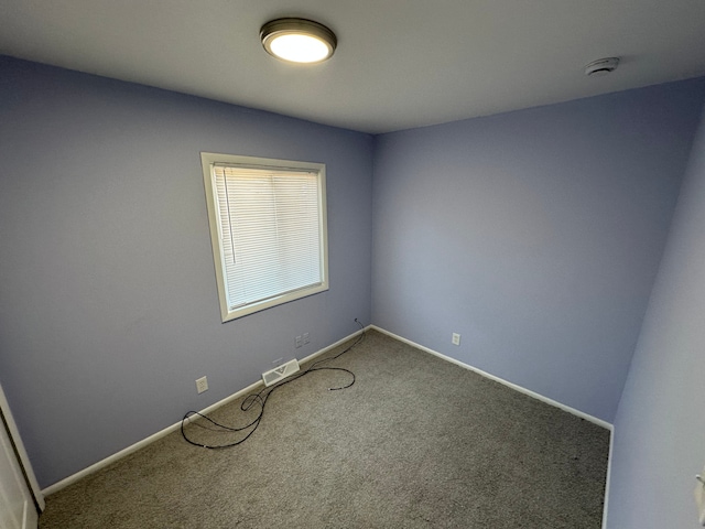 carpeted empty room with baseboards