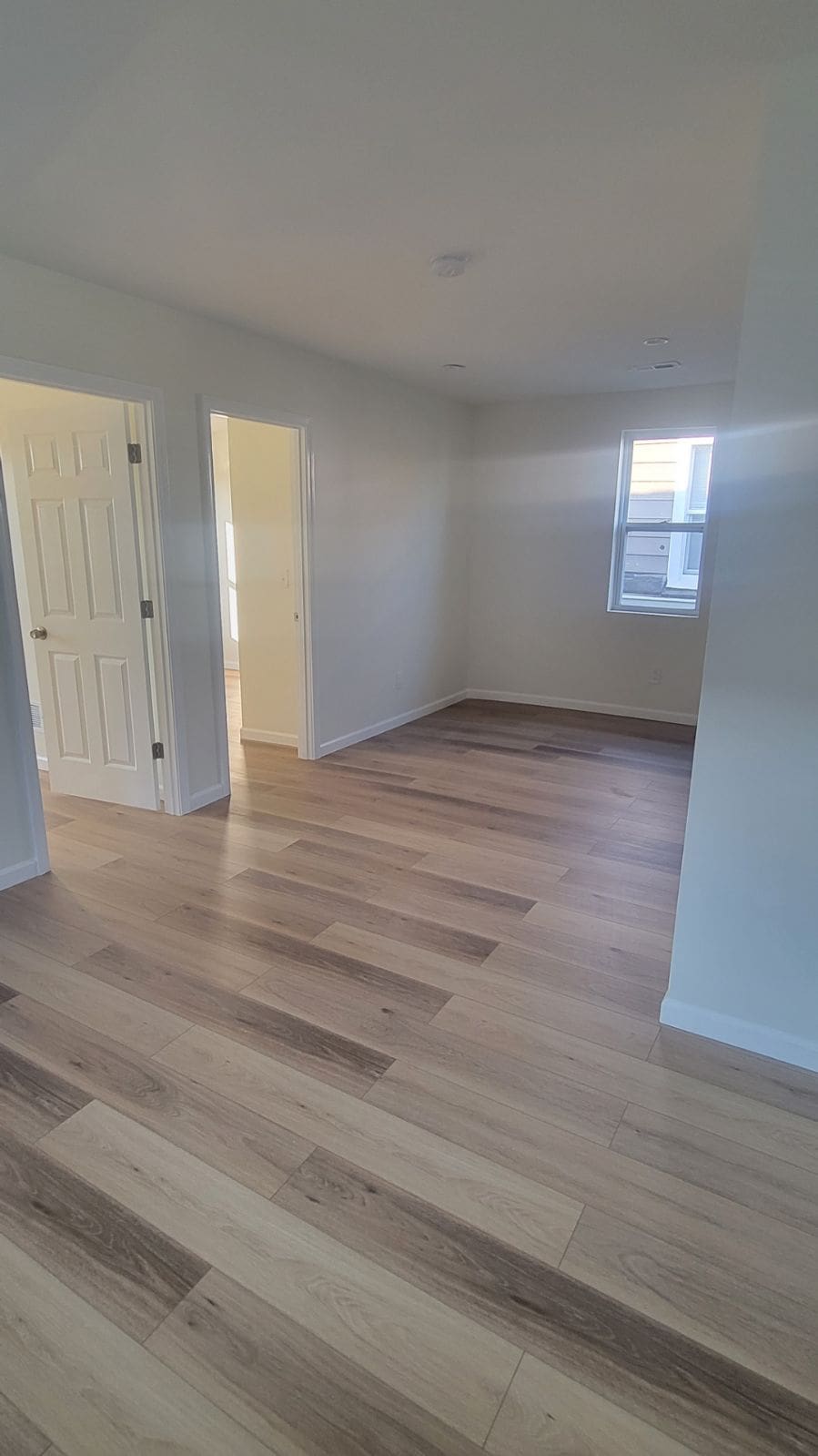 unfurnished room featuring light wood-style flooring and baseboards