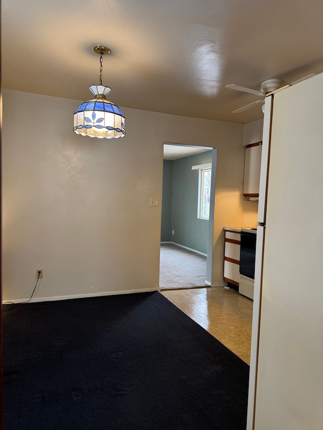 spare room featuring baseboards and a ceiling fan