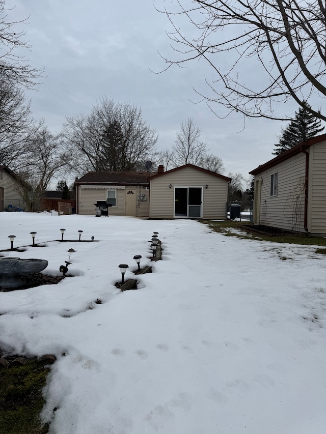 yard covered in snow featuring a garage