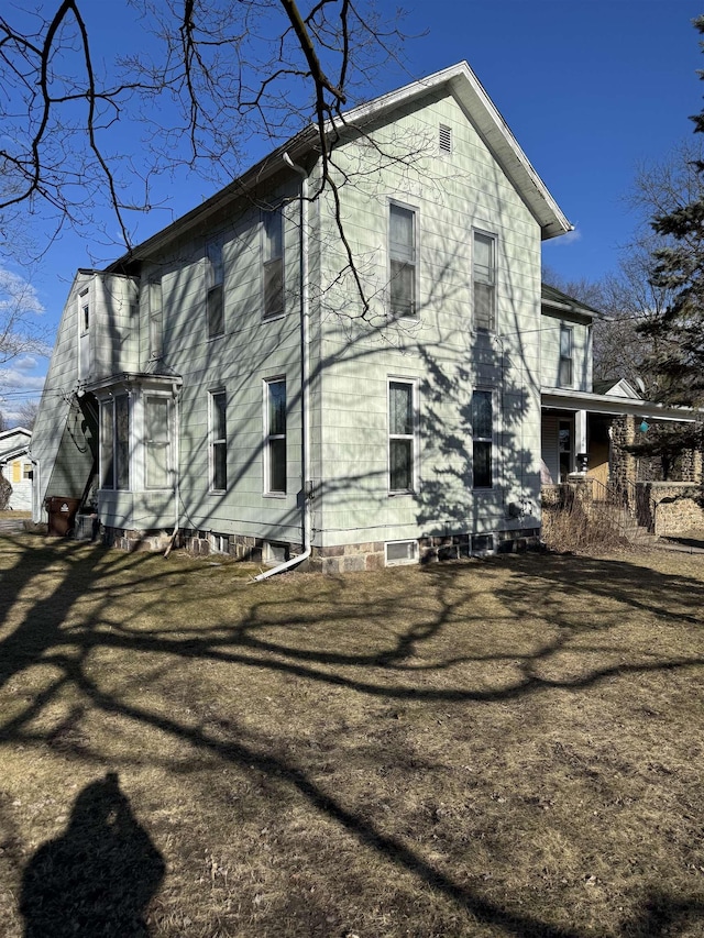 rear view of property featuring entry steps