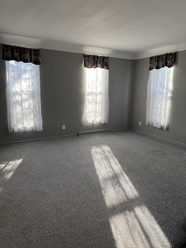 spare room with carpet and baseboards