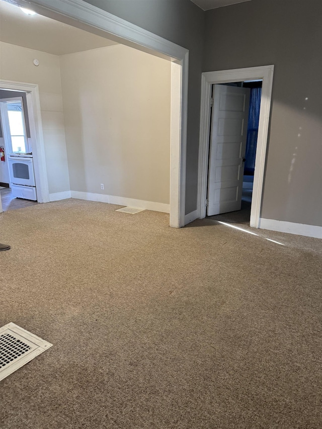 unfurnished bedroom with carpet flooring, visible vents, and baseboards
