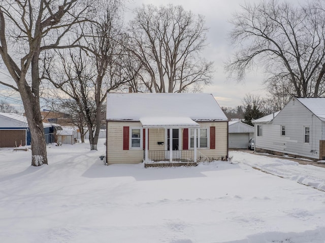 bungalow featuring a garage and a porch