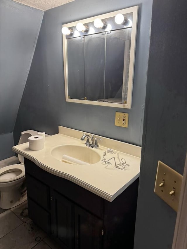 bathroom with vanity, toilet, and tile patterned floors