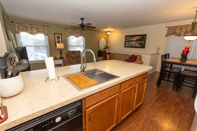 kitchen with dark wood-style flooring, a sink, black dishwasher, light countertops, and open floor plan