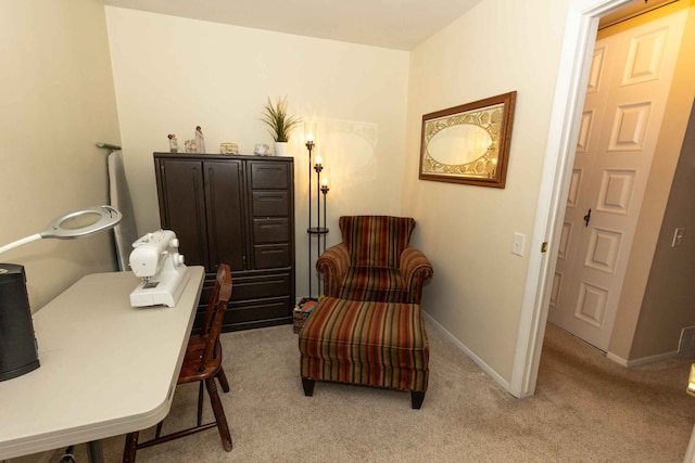 sitting room with light carpet, visible vents, and baseboards