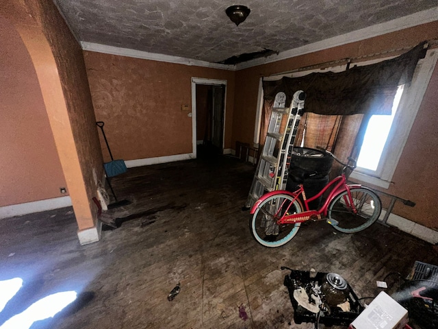 interior space featuring crown molding and baseboards