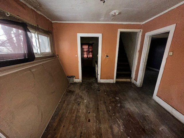 interior space featuring stairs, wood finished floors, and crown molding