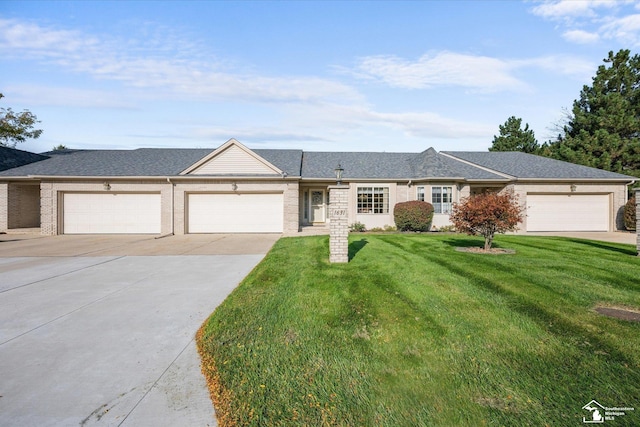 ranch-style home with driveway, an attached garage, a front lawn, and a shingled roof