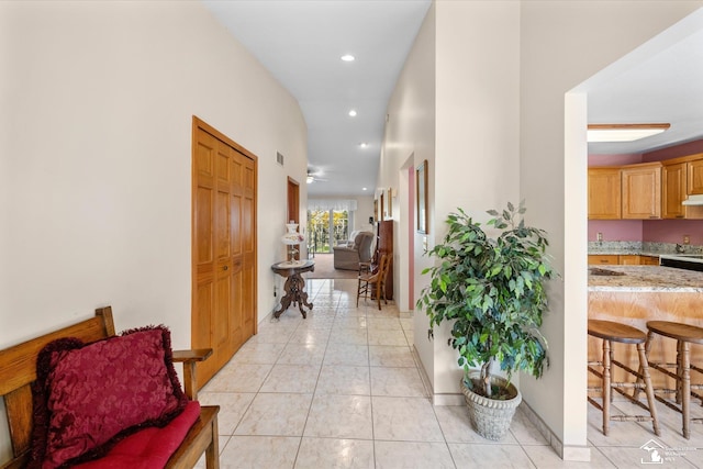 hallway featuring light tile patterned floors, visible vents, and recessed lighting