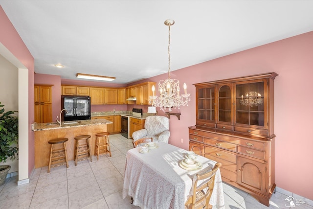 dining room with a notable chandelier and light tile patterned floors