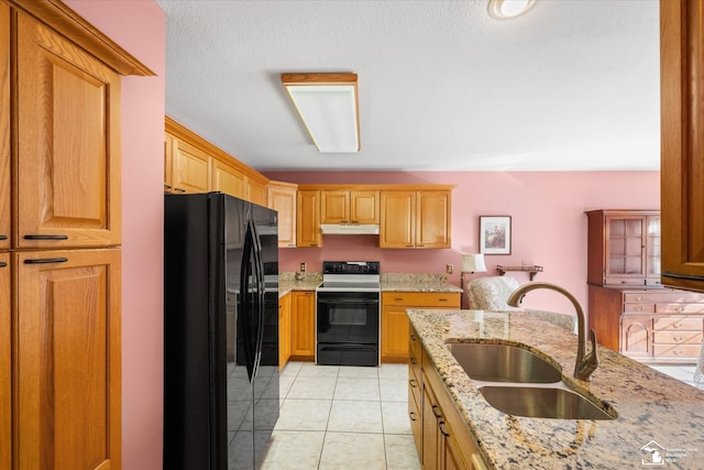 kitchen featuring light tile patterned floors, black fridge with ice dispenser, electric range oven, a sink, and under cabinet range hood