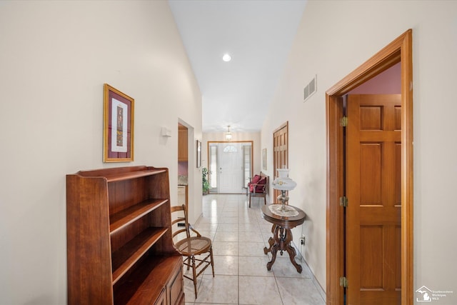 hallway with light tile patterned floors, baseboards, visible vents, and recessed lighting