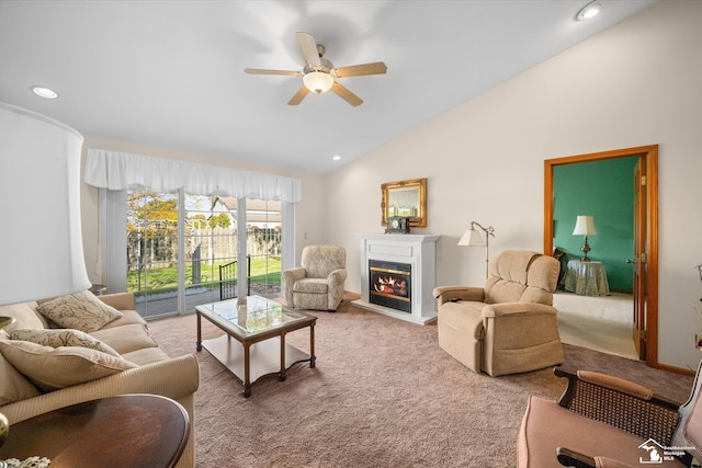 carpeted living area with a glass covered fireplace, vaulted ceiling, recessed lighting, and ceiling fan