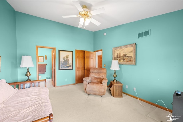 carpeted bedroom featuring baseboards, visible vents, ceiling fan, and ensuite bathroom