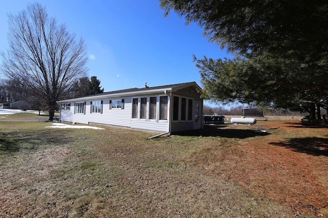 view of front of house with a front yard and a sunroom