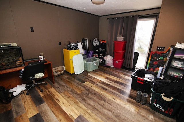 office space with ornamental molding, a textured ceiling, and wood finished floors