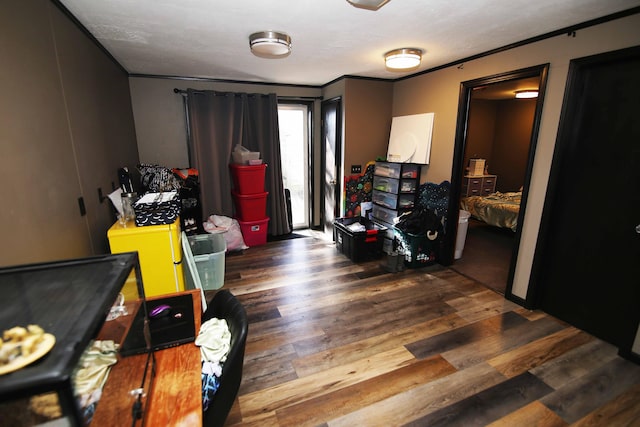 bedroom featuring ornamental molding, access to exterior, and wood finished floors