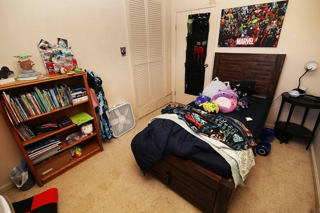 carpeted bedroom featuring a closet and baseboards