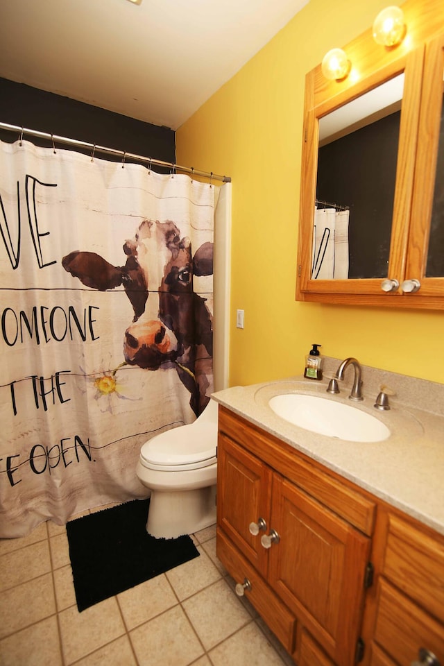 bathroom with toilet, curtained shower, tile patterned flooring, and vanity