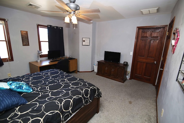 carpeted bedroom with visible vents and ceiling fan