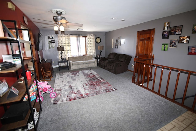 carpeted living room with ceiling fan and baseboards