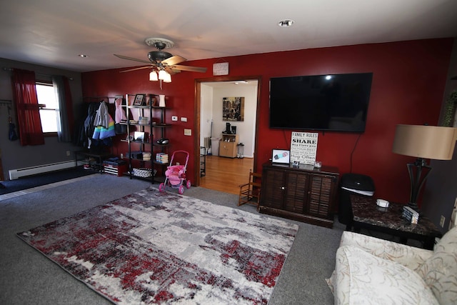 living room featuring a ceiling fan and baseboard heating