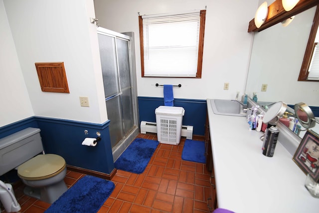 bathroom featuring a baseboard heating unit, brick floor, a shower stall, and toilet