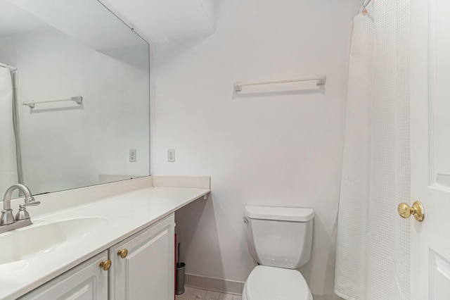 full bathroom with toilet, baseboards, and vanity