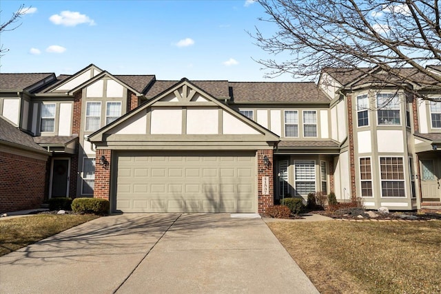 view of front of house with roof with shingles, concrete driveway, brick siding, an attached garage, and stucco siding